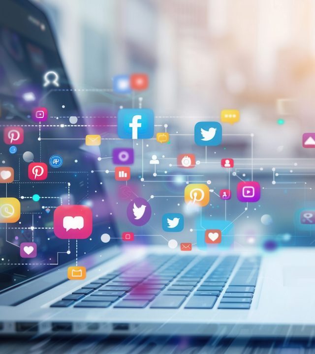 a close up image of a laptop with social media icons floating above the keyboard, representing digital engagement and online marketing. generative ai